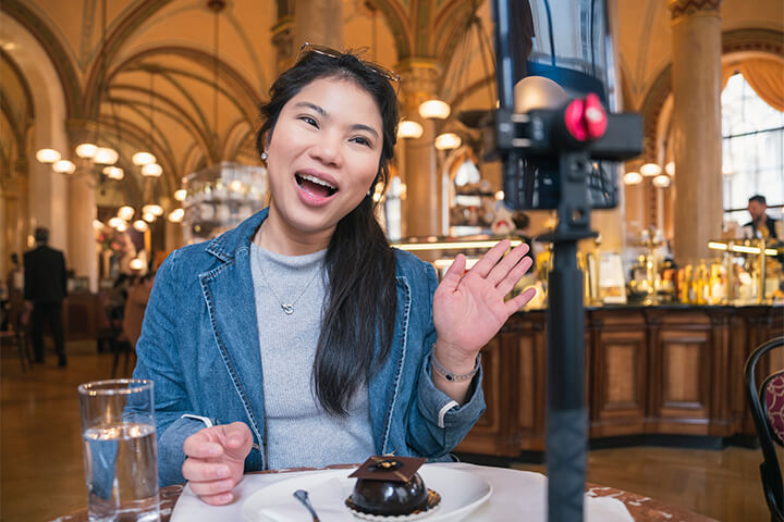 An influencer makes a video in a restaurant (that honestly looks like Grand Central Station)