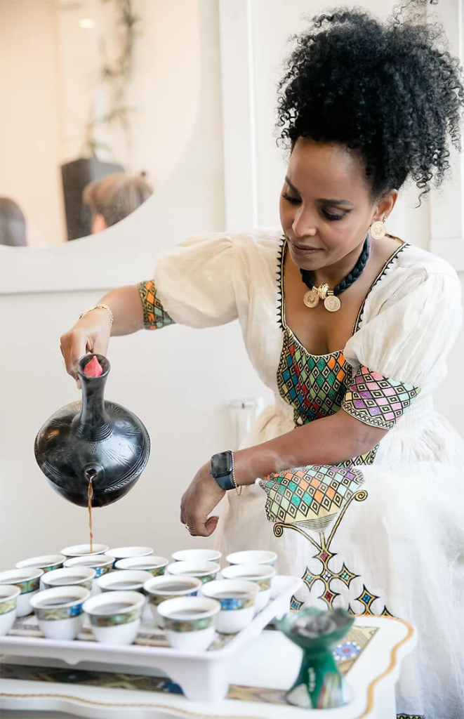 Menal Kidane preparing coffee.