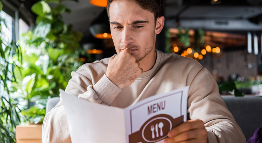 A man contemplates his food choices.