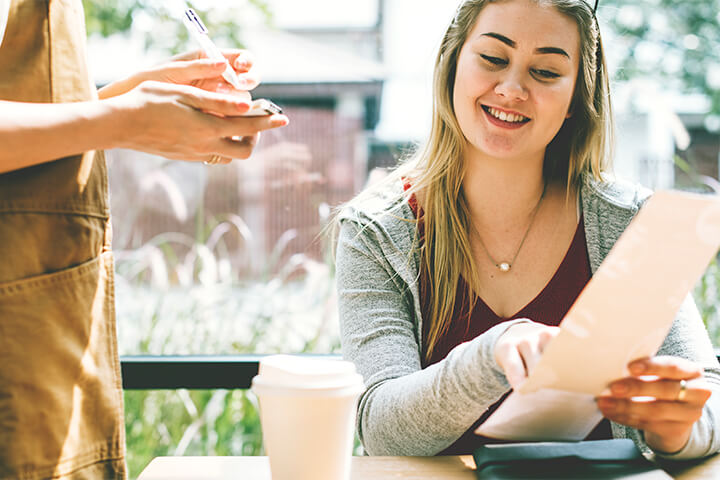 A woman orders off the menu.