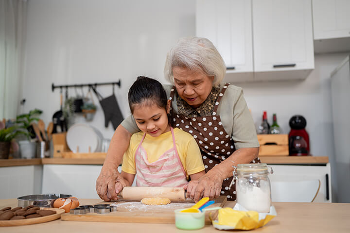Grandma in the kitchen with her grandchild. 
