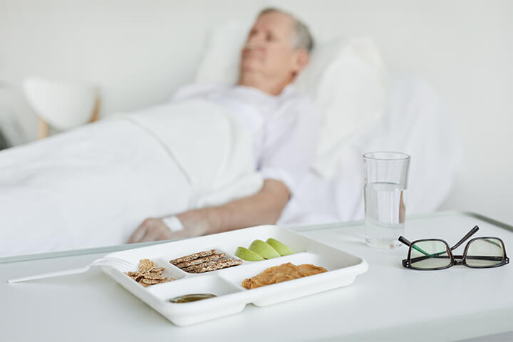A man sleeps while his food gets cold.