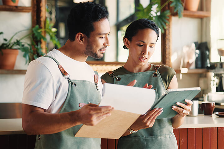 One employee shows another employee some information.