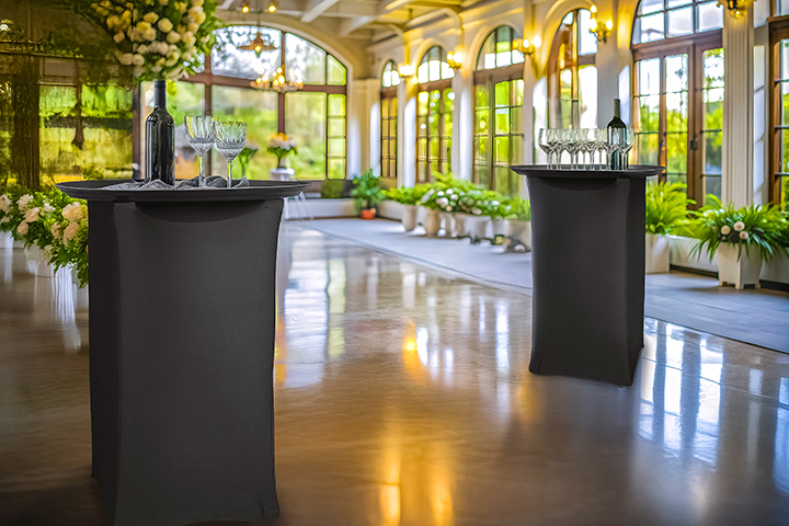A beautiful venue that includes stands with fabric coverings.